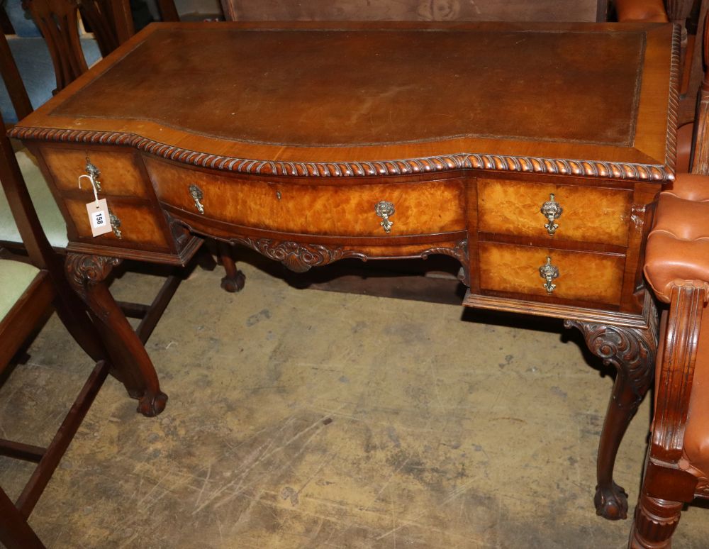 A Queen Anne style walnut bow front leather topped kneehole writing table, W.106cm, D.52cm, H.76cm